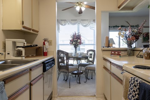 A kitchen with a table and chairs in the middle of it.